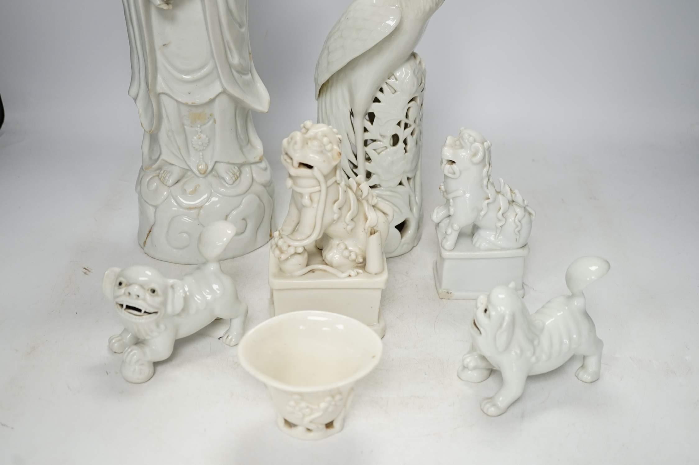 Seven Chinese blanc de chine pieces to include a pair of lion dogs and a phoenix, 17th century and later, largest 44cm high. Condition - varies, poor to fair